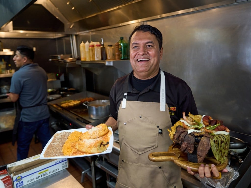 El cocinero y propietario de un restaurante mexicano Marco Mendoza prepara molcajete, un plato tradicional mexicano