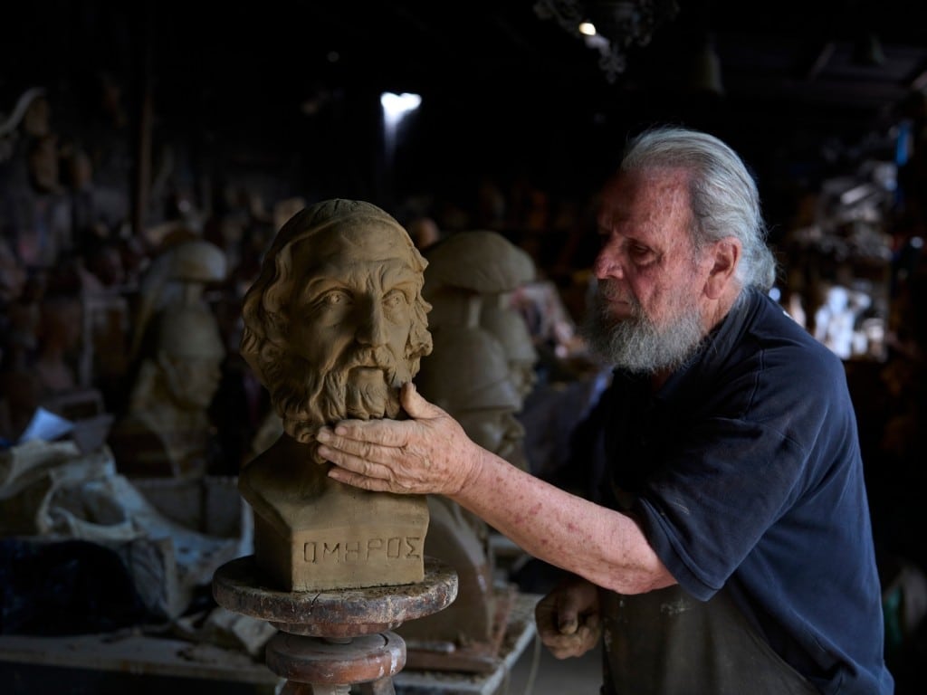 El escultor y ceramista Haralambos Goumas trabaja sobre un busto de terracota del antiguo poeta griego Homero